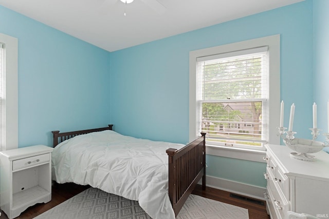 4325 S Wayne Ave, Fort Wayne, IN 46807 - bedroom with dark wood-style flooring, multiple windows, and baseboards