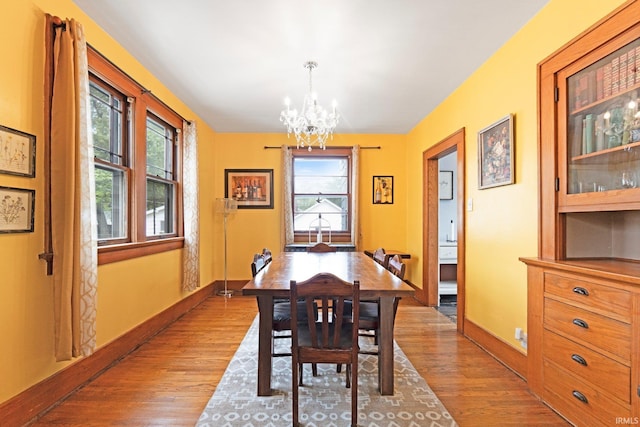 4325 S Wayne Ave, Fort Wayne, IN 46807 - dining space with wood finished floors, a chandelier, and baseboards