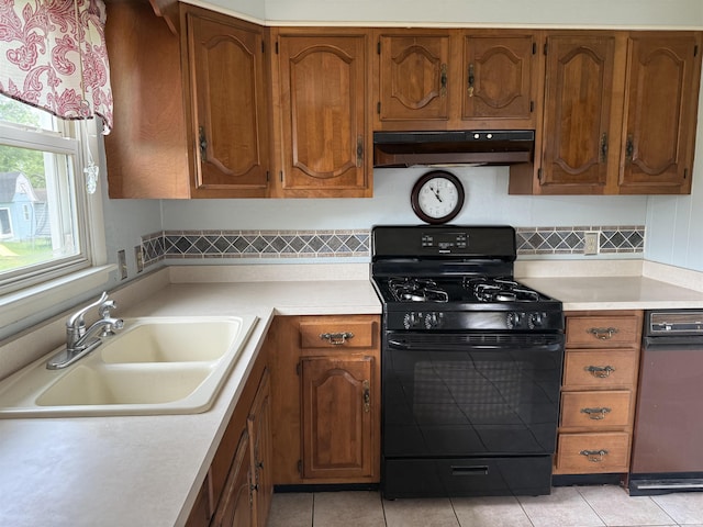 205 Riley Blvd, Bedford, IN 47421 - kitchen with black range with gas stovetop, under cabinet range hood, a sink, and light countertops