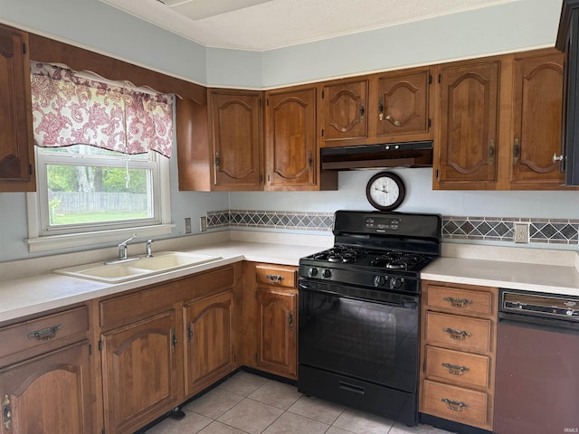 205 Riley Blvd, Bedford, IN 47421 - kitchen featuring black gas stove, under cabinet range hood, a sink, light countertops, and backsplash