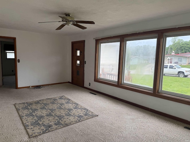 205 Riley Blvd, Bedford, IN 47421 - foyer with light carpet, a ceiling fan, baseboards, and a textured ceiling