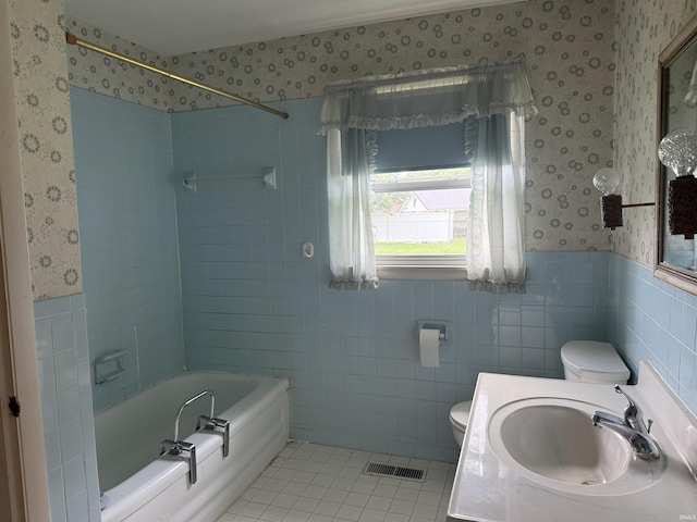 205 Riley Blvd, Bedford, IN 47421 - full bathroom featuring wallpapered walls, toilet, a wainscoted wall, tile walls, and bathtub / shower combination