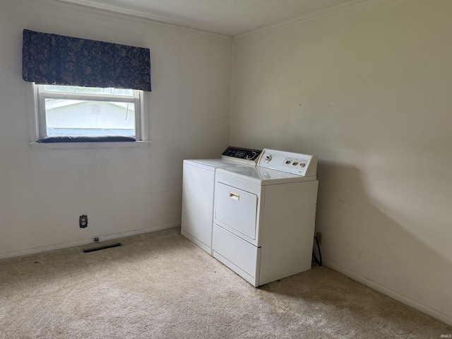 205 Riley Blvd, Bedford, IN 47421 - laundry room with washer and dryer, light colored carpet, and crown molding