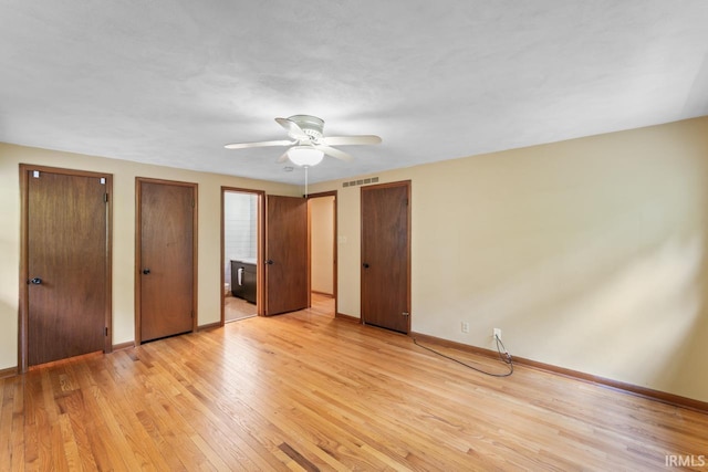 2730 Newman Rd, West Lafayette, IN 47906 - unfurnished bedroom featuring light wood-style flooring, two closets, and baseboards