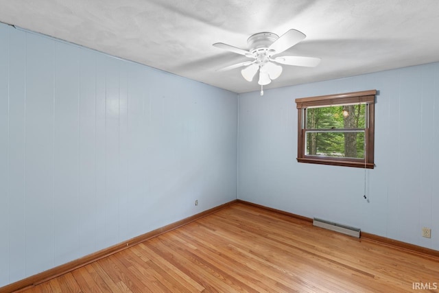 2730 Newman Rd, West Lafayette, IN 47906 - spare room featuring a baseboard heating unit, light wood-style floors, baseboards, and a ceiling fan