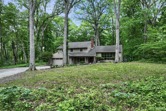 2730 Newman Rd, West Lafayette, IN 47906 - view of front of home with a chimney, a garage, concrete driveway, and central air condition unit