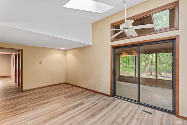 2730 Newman Rd, West Lafayette, IN 47906 - spare room featuring a skylight, wood finished floors, baseboards, a ceiling fan, and high vaulted ceiling