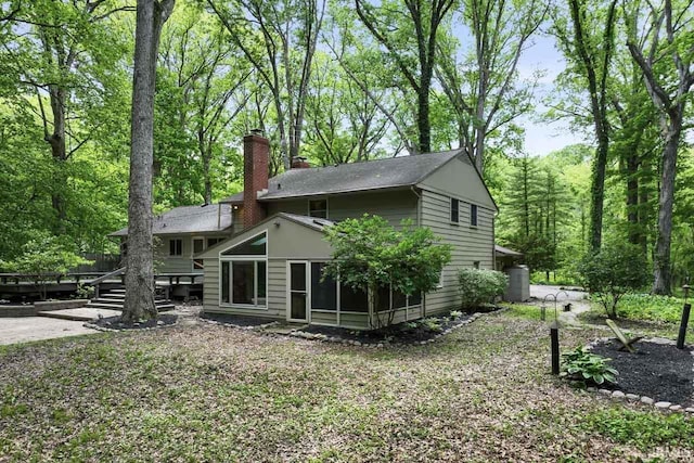 2730 Newman Rd, West Lafayette, IN 47906 - back of property featuring a deck, a chimney, and a sunroom