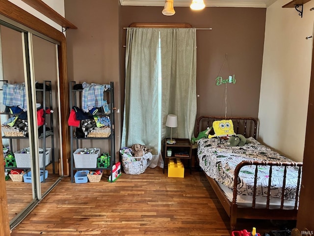 35 W Pine St, Knightstown, IN 46148 - bedroom with wood finished floors, crown molding, and a closet