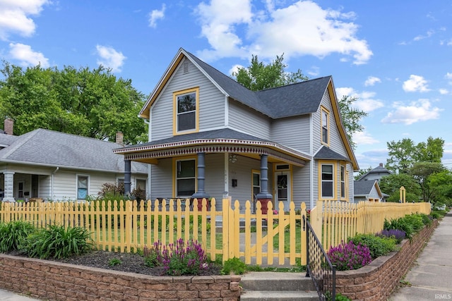 1824 Maple St, Lafayette, IN 47904 - victorian house featuring covered porch, a gate, a fenced front yard, and a shingled roof