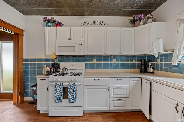 1824 Maple St, Lafayette, IN 47904 - kitchen featuring white appliances, an ornate ceiling, wood finished floors, white cabinetry, and light countertops