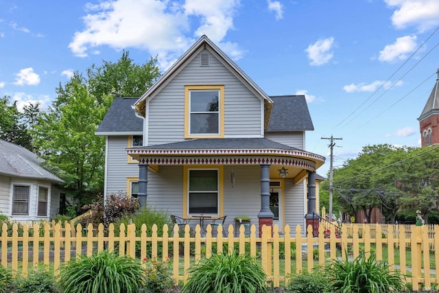 1824 Maple St, Lafayette, IN 47904 - view of front facade featuring a porch, a shingled roof, and a fenced front yard