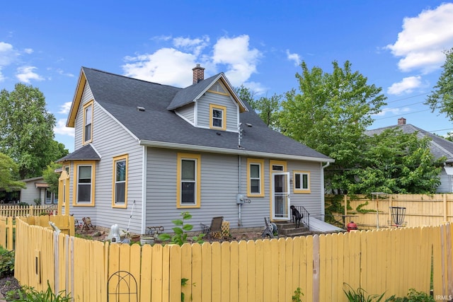 1824 Maple St, Lafayette, IN 47904 - back of house with a fenced backyard, roof with shingles, a chimney, and entry steps