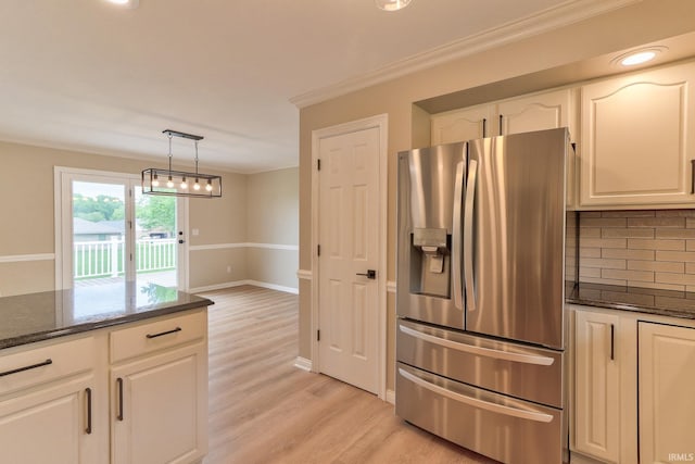 11216 Kramers Dr, Evansville, IN 47712 - kitchen featuring stainless steel refrigerator with ice dispenser, crown molding, tasteful backsplash, dark stone counters, and light wood-style floors