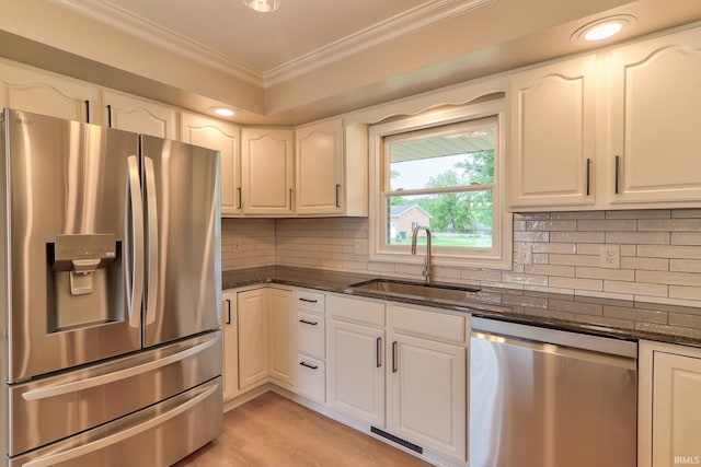 11216 Kramers Dr, Evansville, IN 47712 - kitchen featuring stainless steel appliances, a sink, crown molding, dark stone counters, and white cabinets