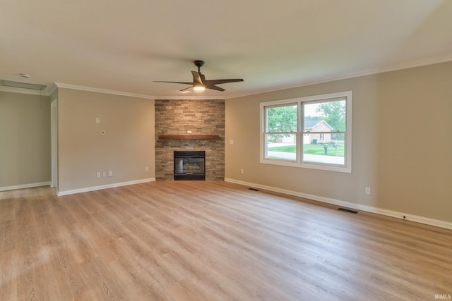 11216 Kramers Dr, Evansville, IN 47712 - unfurnished living room with light wood-style flooring, ceiling fan, crown molding, a fireplace, and baseboards