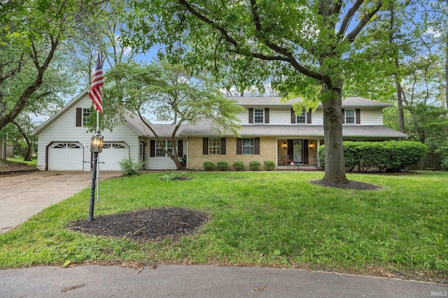 3301 Cedar Ln, Lafayette, IN 47905 - traditional-style house featuring an attached garage, driveway, a front yard, covered porch, and roof with shingles