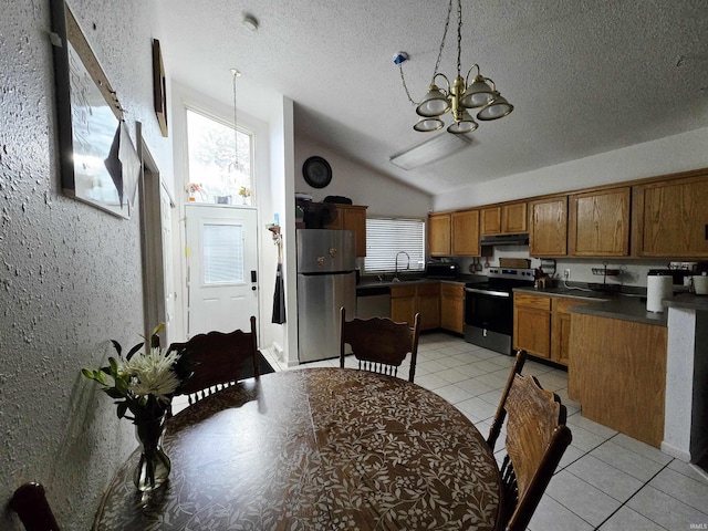 2038 Shaw Ave, Peru, IN 46970 - kitchen with stainless steel appliances, a chandelier, brown cabinetry, dark countertops, and a textured ceiling