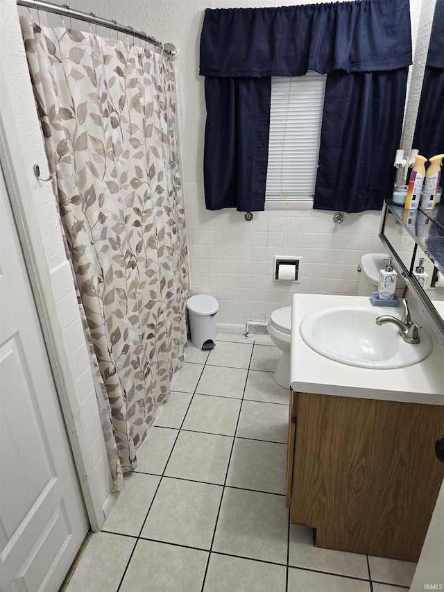 2038 Shaw Ave, Peru, IN 46970 - full bath with tile patterned flooring, vanity, toilet, tile walls, and curtained shower