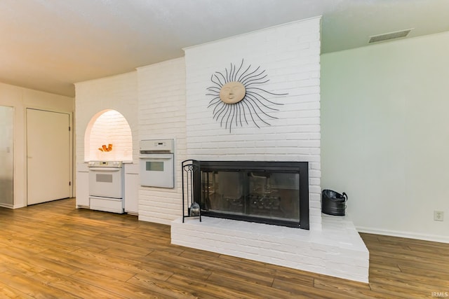6607 W Ryan Dr, Anderson, IN 46011 - living area with a fireplace, wood finished floors, and baseboards