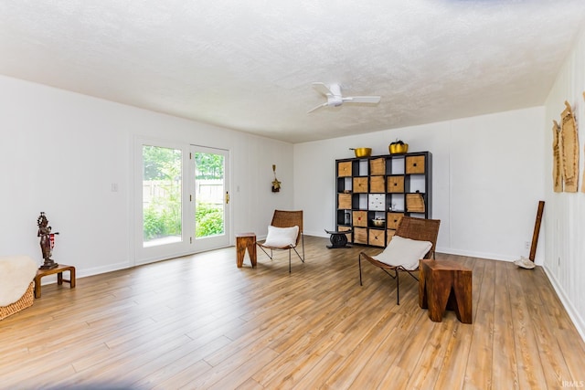 6607 W Ryan Dr, Anderson, IN 46011 - sitting room featuring ceiling fan, wood finished floors, baseboards, and a textured ceiling