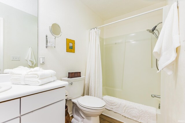 6607 W Ryan Dr, Anderson, IN 46011 - full bathroom with vanity, toilet, wood finished floors, and shower / tub combo with curtain