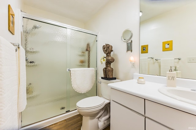 6607 W Ryan Dr, Anderson, IN 46011 - full bath with vanity, a shower stall, wood finished floors, and toilet