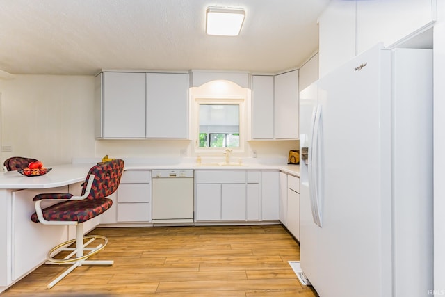 6607 W Ryan Dr, Anderson, IN 46011 - kitchen with white appliances, a sink, light wood-type flooring, light countertops, and white cabinetry