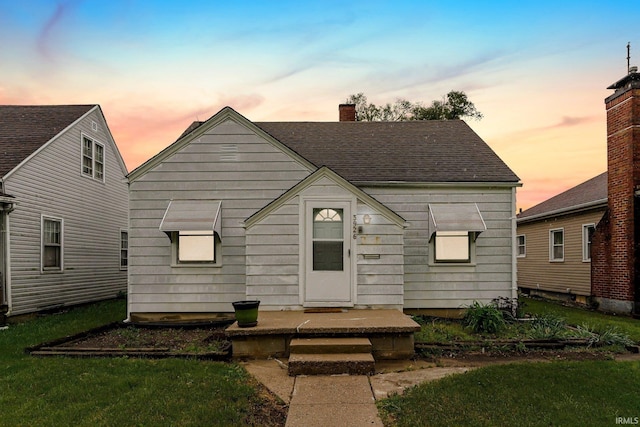 3926 S Park Dr, Fort Wayne, IN 46806 - view of front of home with a chimney, roof with shingles, and a yard