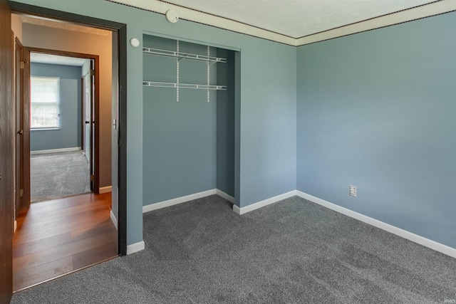 1708 Mason Dixon Dr, West Lafayette, IN 47906 - unfurnished bedroom with dark colored carpet, a closet, and baseboards