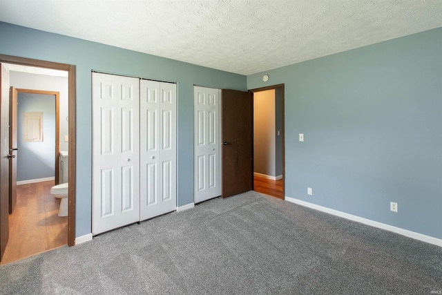 1708 Mason Dixon Dr, West Lafayette, IN 47906 - unfurnished bedroom with two closets, baseboards, carpet, and a textured ceiling