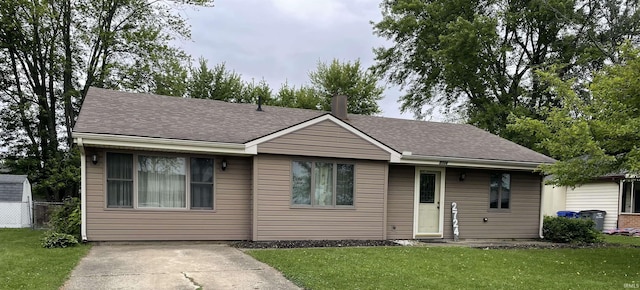2724 Elva Dr, Kokomo, IN 46902 - view of front of property with a front lawn, a shingled roof, and a chimney