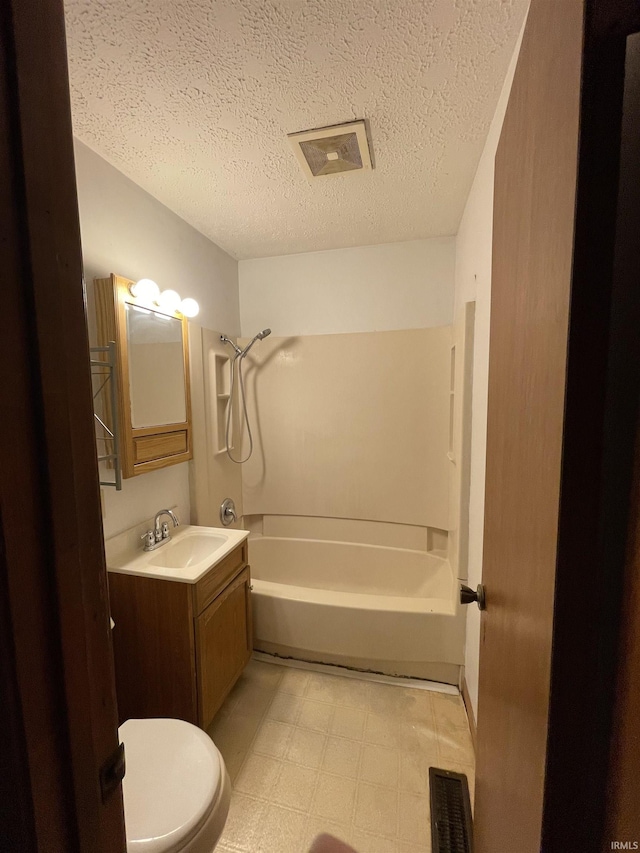 2724 Elva Dr, Kokomo, IN 46902 - bathroom featuring toilet, vanity, a textured ceiling, washtub / shower combination, and tile patterned floors