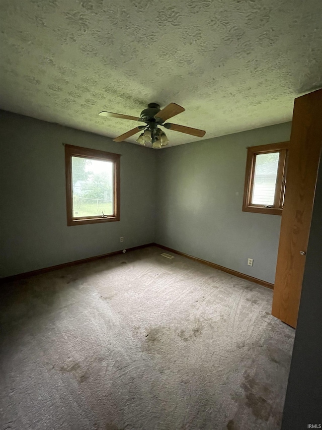 2724 Elva Dr, Kokomo, IN 46902 - carpeted spare room featuring a textured ceiling, baseboards, and a ceiling fan
