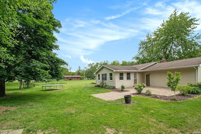 1453 Brookview Ave, Warsaw, IN 46580 - view of green lawn featuring a patio area and a trampoline