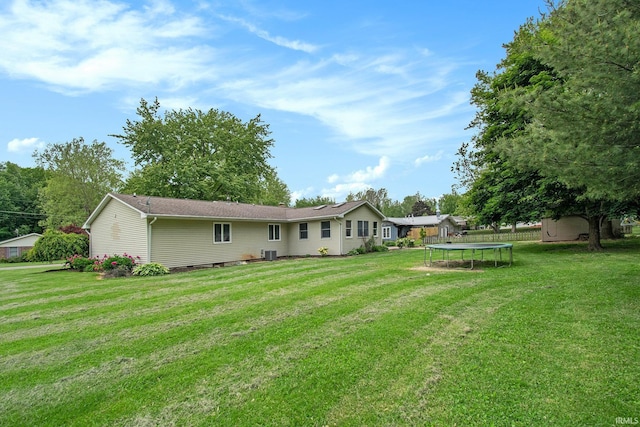1453 Brookview Ave, Warsaw, IN 46580 - rear view of property with a trampoline and a lawn