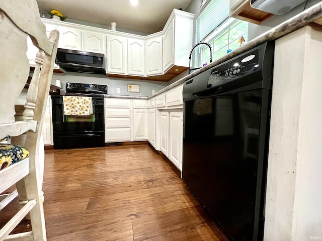 348 N Dover Clfs, Ellettsville, IN 47429 - kitchen featuring stainless steel microwave, black range with electric stovetop, white cabinetry, and dark wood finished floors