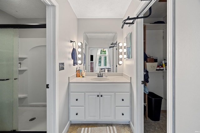 2218 Wake Robin Dr, West Lafayette, IN 47906 - full bathroom featuring a stall shower, vanity, tile patterned flooring, and a textured ceiling