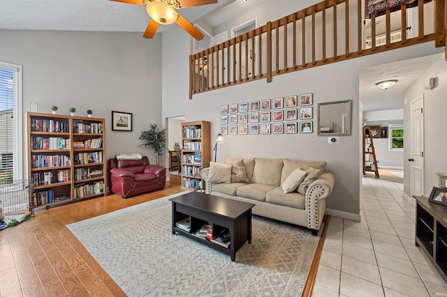 2218 Wake Robin Dr, West Lafayette, IN 47906 - living area featuring high vaulted ceiling, a ceiling fan, light tile patterned floors, and baseboards