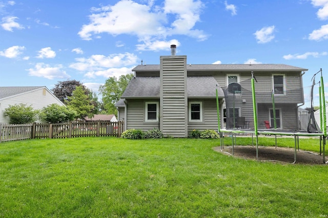 2218 Wake Robin Dr, West Lafayette, IN 47906 - back of house with a trampoline, a chimney, and roof with shingles