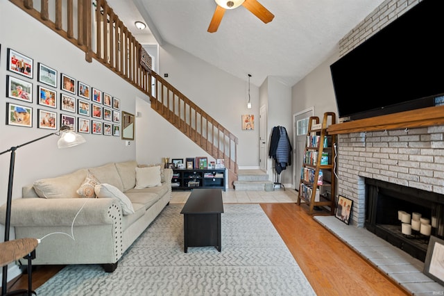 2218 Wake Robin Dr, West Lafayette, IN 47906 - living area featuring a ceiling fan, stairs, wood finished floors, a fireplace, and a textured ceiling