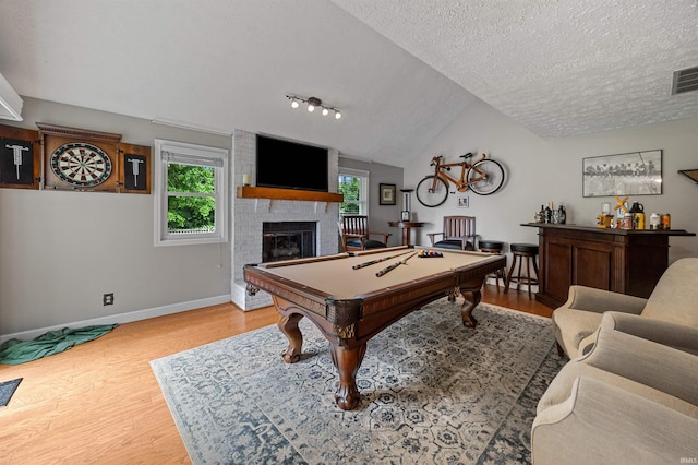 2218 Wake Robin Dr, West Lafayette, IN 47906 - game room with healthy amount of natural light, pool table, wood finished floors, a textured ceiling, and vaulted ceiling