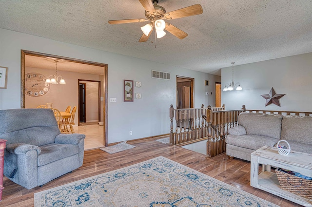907 Nicholas Dr, Boonville, IN 47601 - living area with a chandelier, a textured ceiling, wood finished floors, and ceiling fan