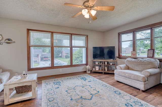 907 Nicholas Dr, Boonville, IN 47601 - living area with a textured ceiling, wood finished floors, and a ceiling fan