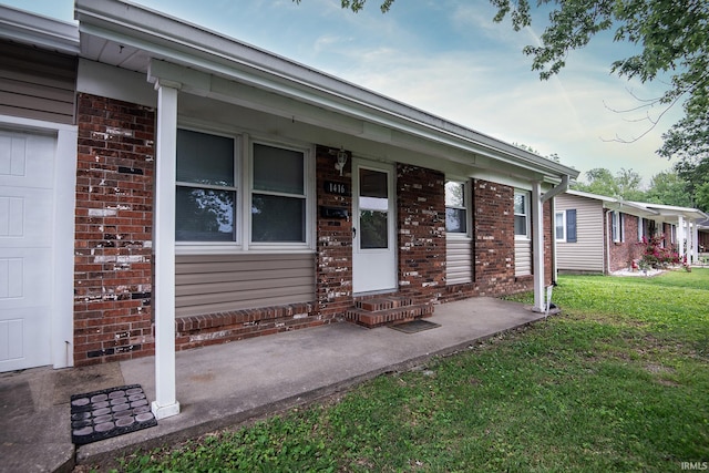 1416 State St, Vincennes, IN 47591 - view of exterior entry with a lawn and brick siding