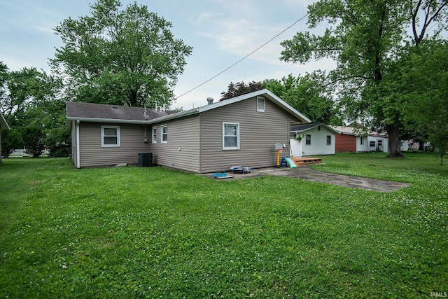 1416 State St, Vincennes, IN 47591 - back of property featuring a yard, central AC, and a patio area