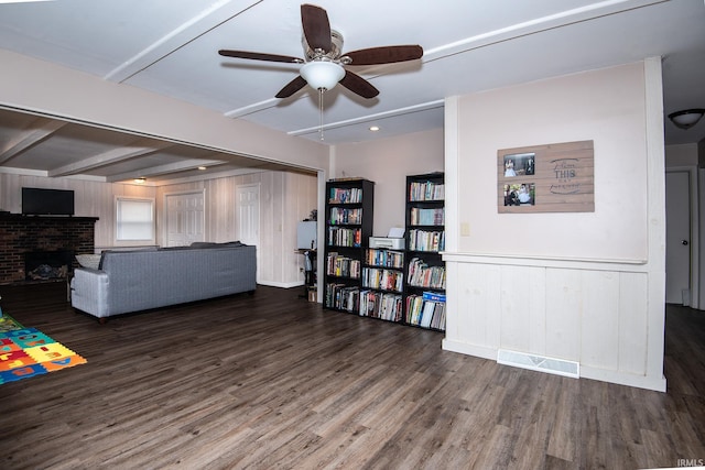 1416 State St, Vincennes, IN 47591 - living room featuring a ceiling fan, wood finished floors, a fireplace, and beamed ceiling