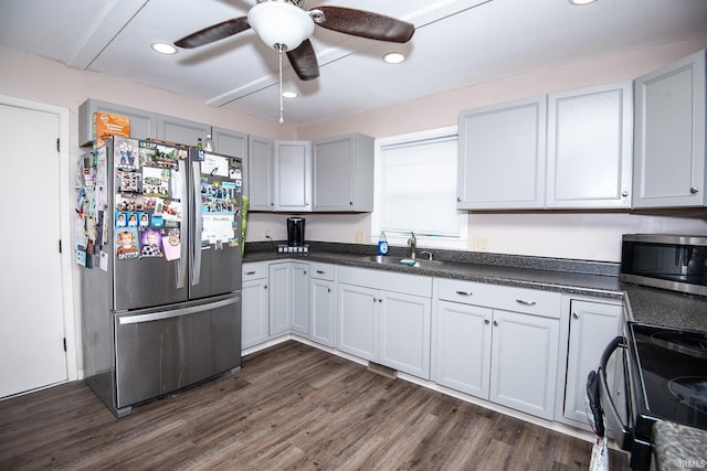 1416 State St, Vincennes, IN 47591 - kitchen featuring stainless steel appliances, a sink, dark countertops, dark wood-type flooring, and recessed lighting