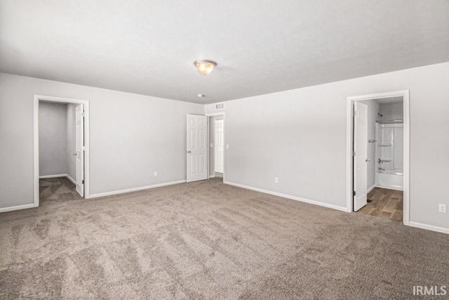 8247 Catberry Trl, Fort Wayne, IN 46804 - unfurnished bedroom featuring carpet, baseboards, a walk in closet, and connected bathroom
