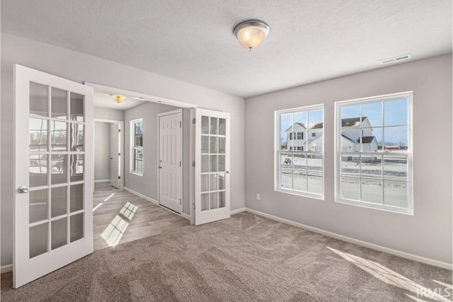 8247 Catberry Trl, Fort Wayne, IN 46804 - carpeted spare room with french doors and baseboards
